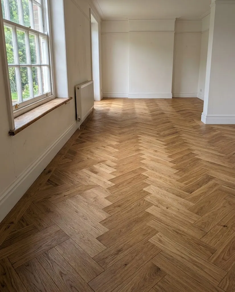 A herringbone oak floor in a freshly painted room.